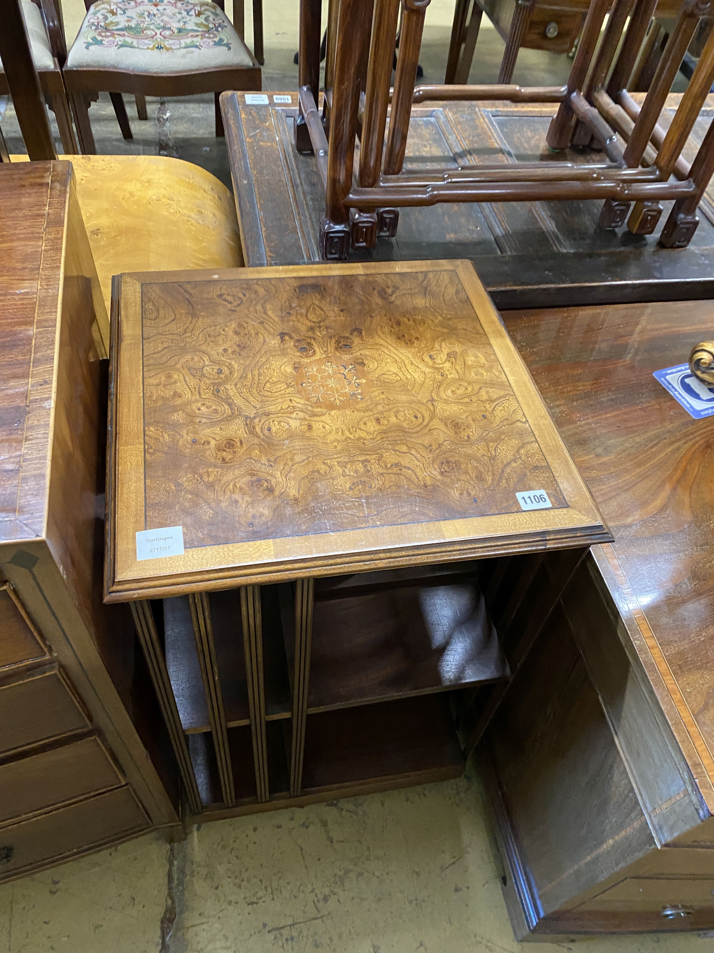 An Edwardian square cross banded elm revolving bookcase, width 48cm, height 83cm